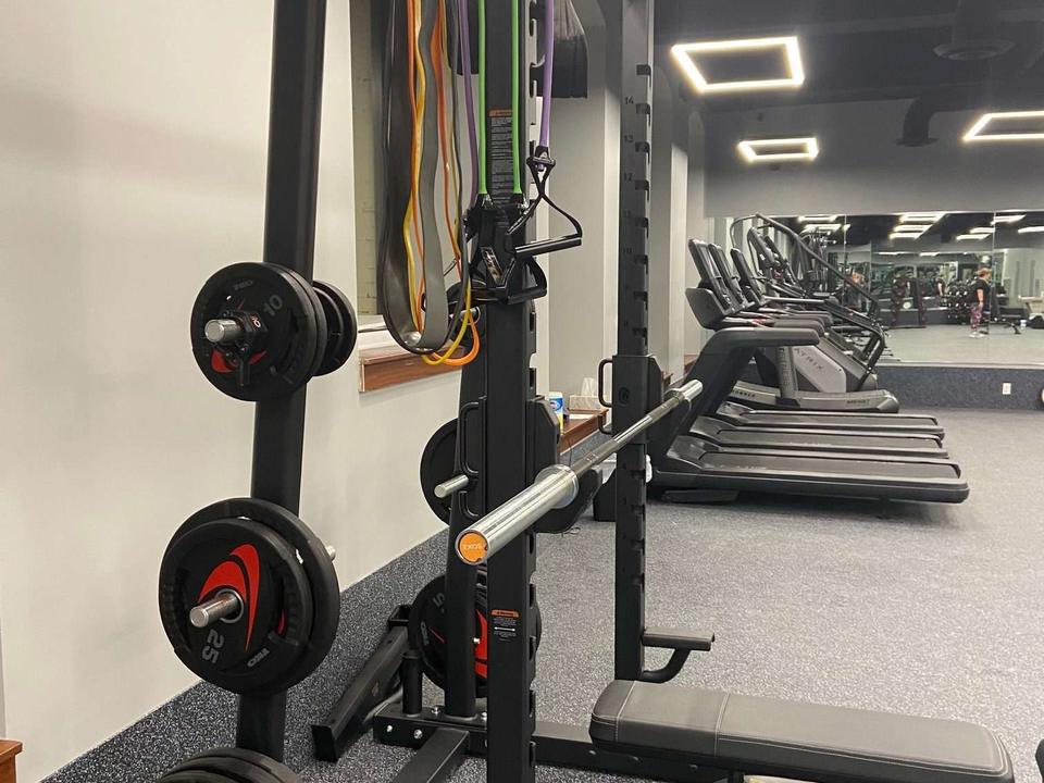 A squat rack loaded with plates on the studio floor